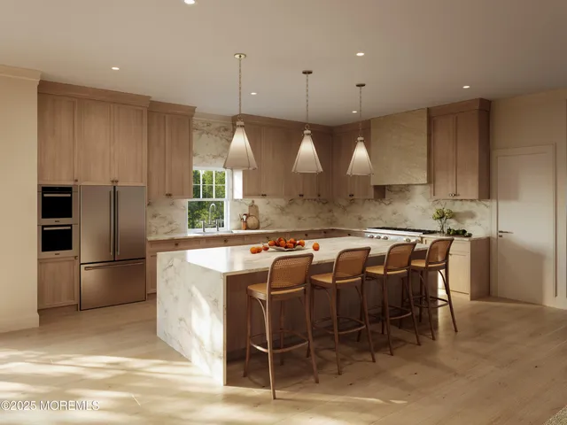 a kitchen with stainless steel appliances granite countertop a sink a stove a refrigerator and island