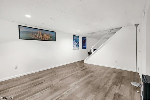 a view of a big room with wooden floor and staircase