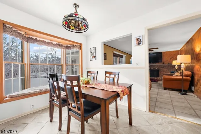 a dining room with furniture and window