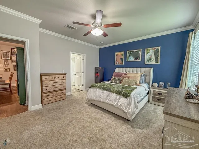 a bedroom with a large bed a chandelier and closet