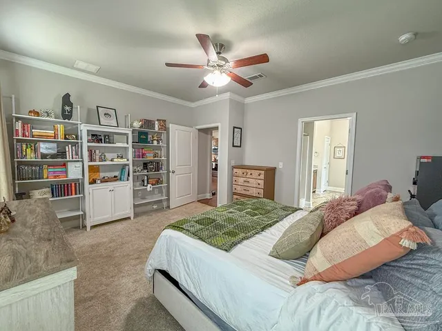 a bedroom with a bed cabinets and window