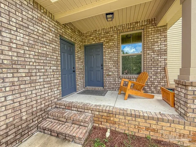 a view of a patio with a table and chairs and wooden floor