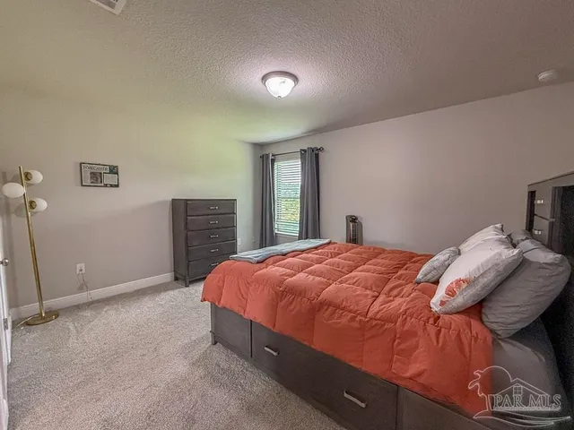 a bed sitting in a bedroom and closet