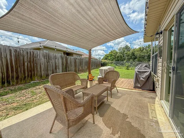 a patio with table and chairs