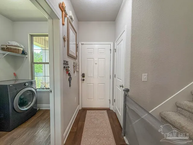 a view of a hallway with washer and dryer