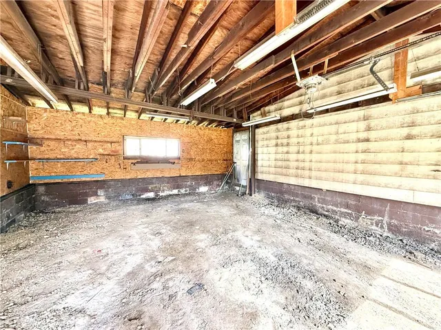 a view of a room with a wooden roof and windows