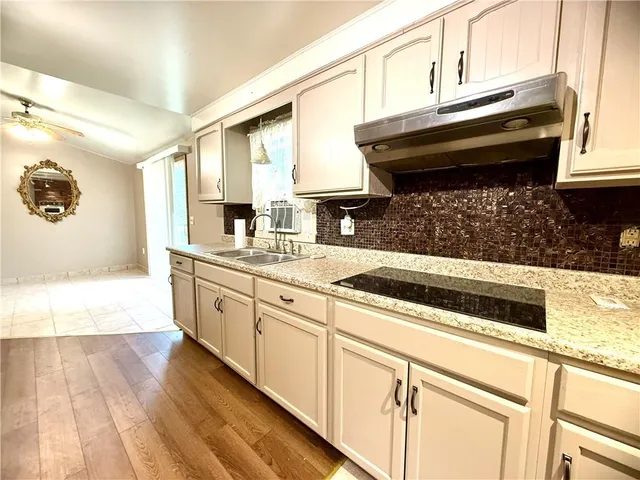 a kitchen with stainless steel appliances a stove a microwave and cabinets