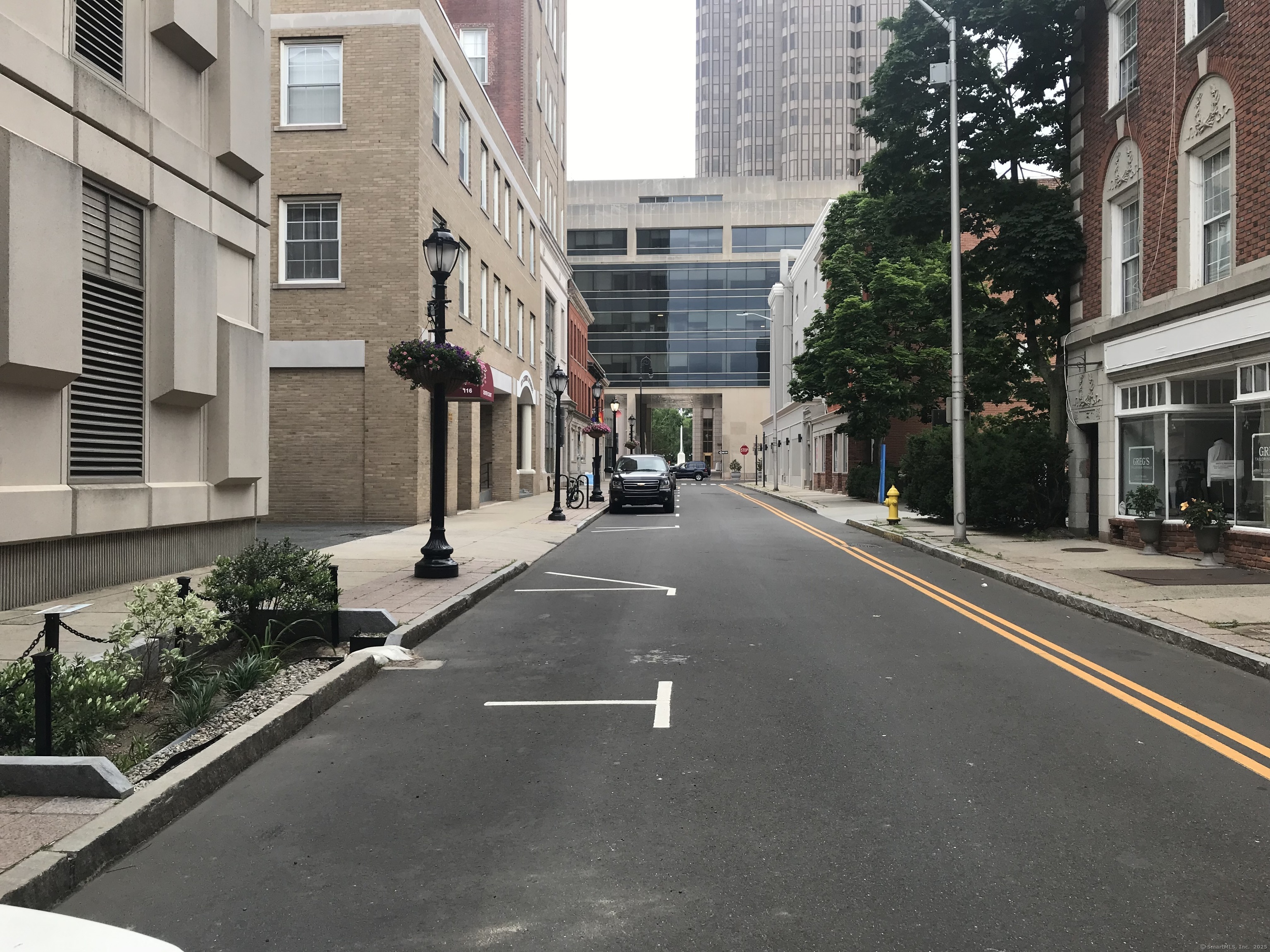 124 Court Street, Unit 1103 New Haven, CT 06511 - Photo 20 of 21 a view of a street with brick building in front of it