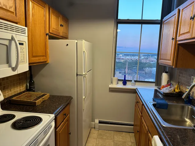 a kitchen with stainless steel appliances a stove a refrigerator and a sink