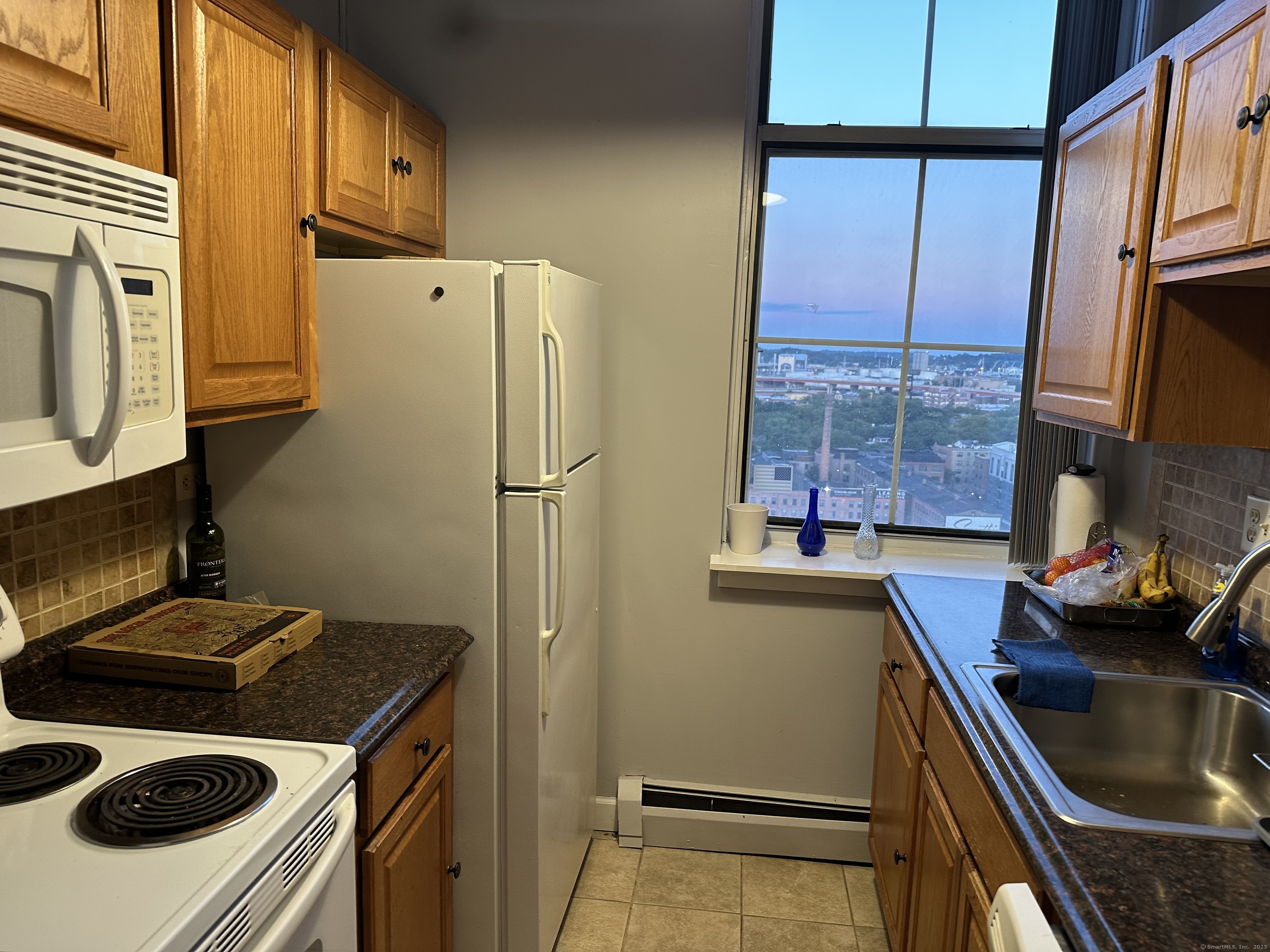 124 Court Street, Unit 1103 New Haven, CT 06511 - Photo 6 of 21 a kitchen with stainless steel appliances a stove a refrigerator and a sink