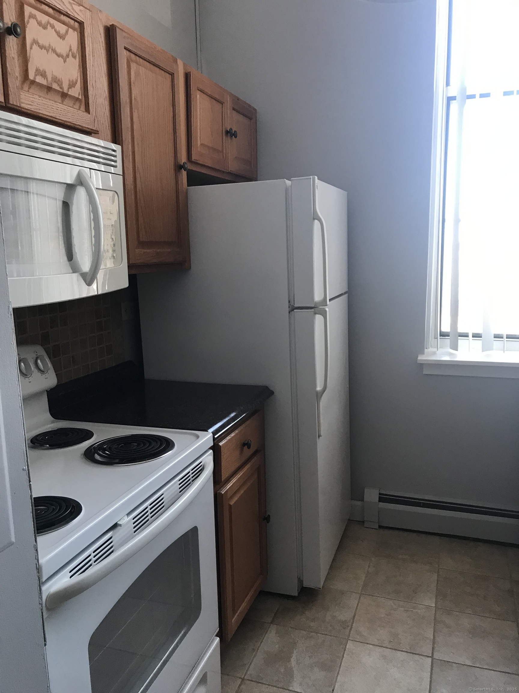 124 Court Street, Unit 1103 New Haven, CT 06511 - Photo 7 of 21 a kitchen with stainless steel appliances a refrigerator and a stove