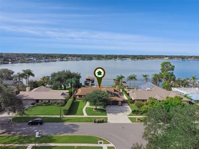 a view of a house with a yard and lake view