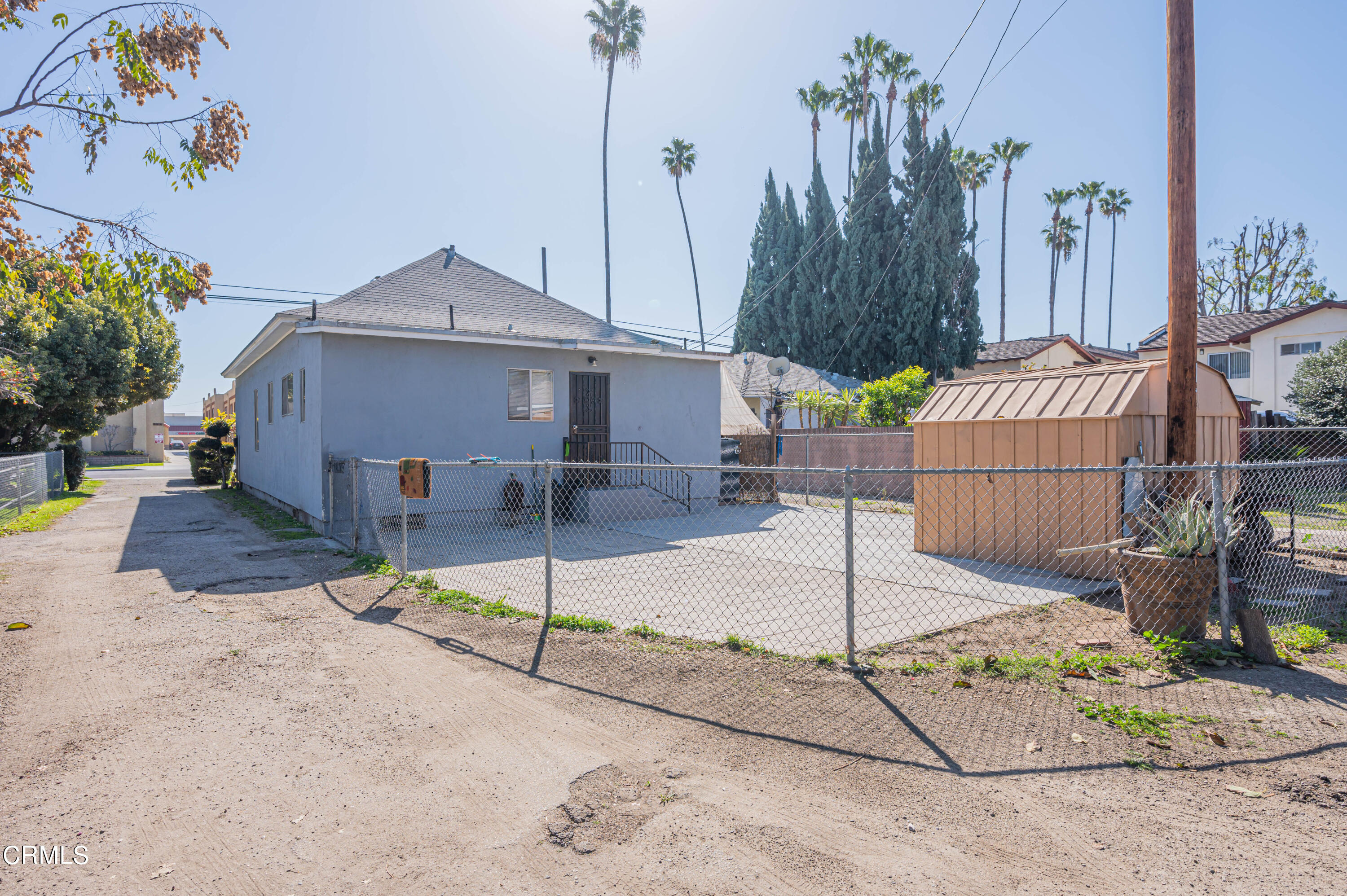 9911 Tweedy Lane Downey, CA 90240 - Photo 12 of 28 a view of a house with a small yard and wooden fence