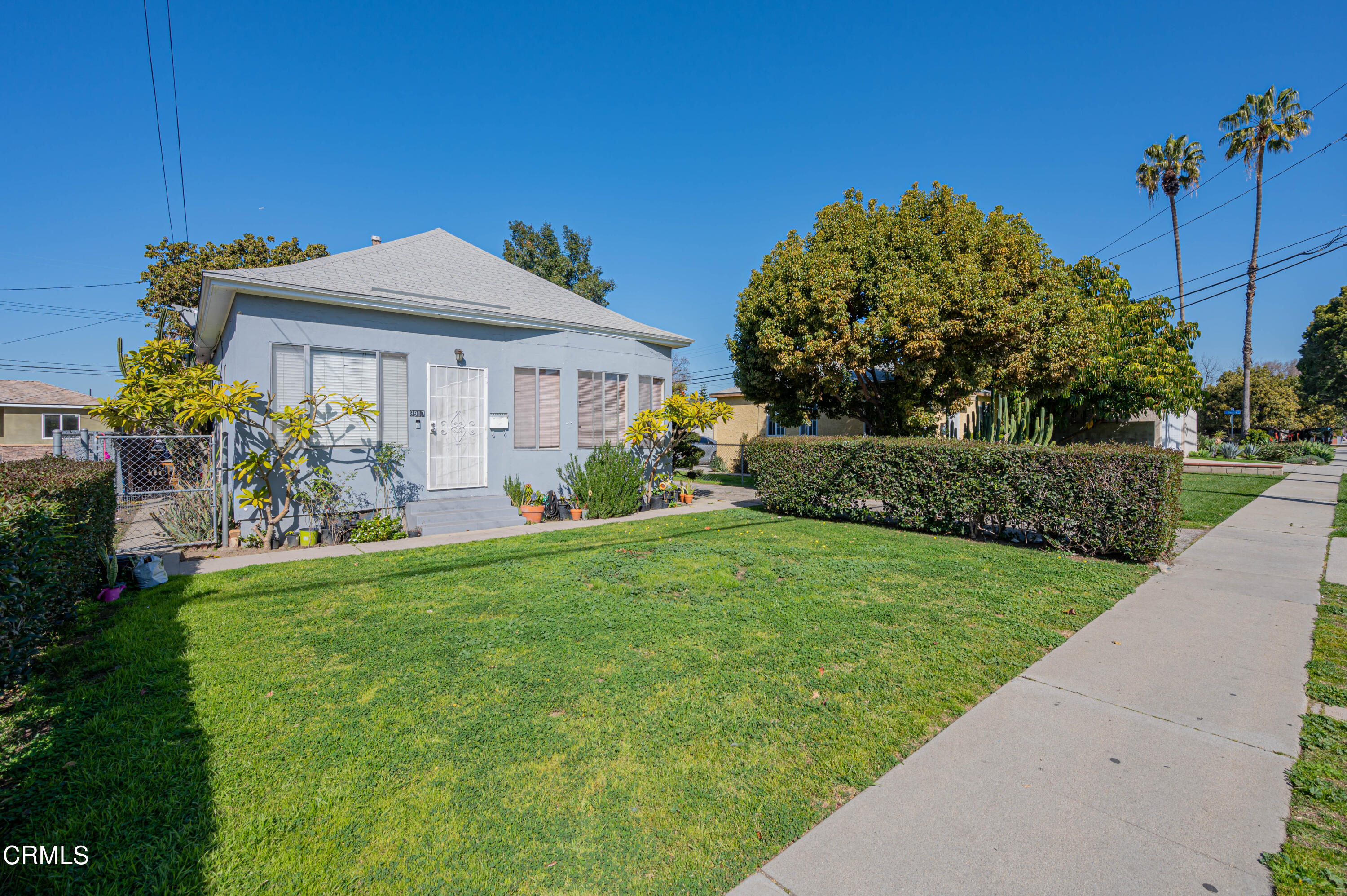 9911 Tweedy Lane Downey, CA 90240 - Photo 9 of 28 a front view of a house with garden