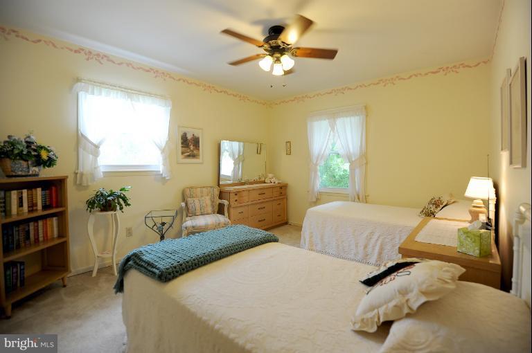 6505 Divine Street McLean, VA 22101 - Photo 13 of 26 a bedroom with two beds and a chandelier