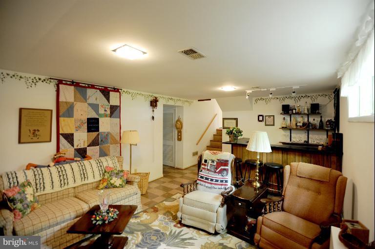 6505 Divine Street McLean, VA 22101 - Photo 16 of 26 a living room with furniture and a wooden floor