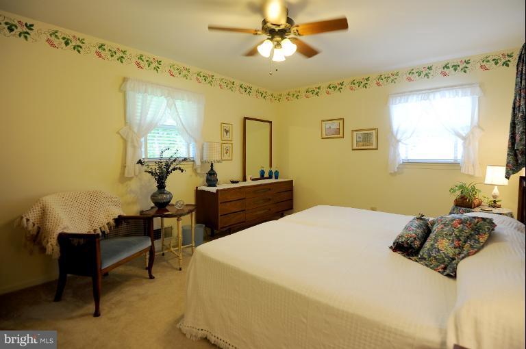 6505 Divine Street McLean, VA 22101 - Photo 17 of 26 a bedroom with a bed and a chandelier