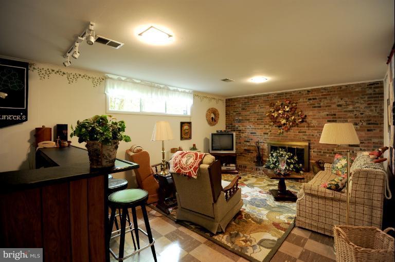 6505 Divine Street McLean, VA 22101 - Photo 21 of 26 a living room with furniture and a lamp