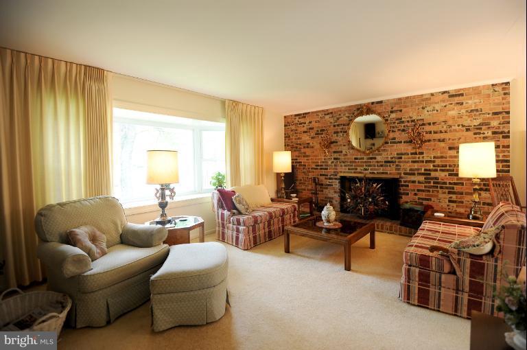 6505 Divine Street McLean, VA 22101 - Photo 4 of 26 a living room with furniture and a fireplace