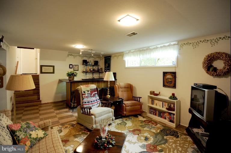 6505 Divine Street McLean, VA 22101 - Photo 6 of 26 a living room with furniture and a flat screen tv