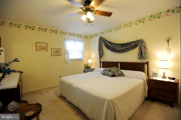 6505 Divine Street McLean, VA 22101 - Photo 8 of 26 a bedroom with a bed and a chandelier