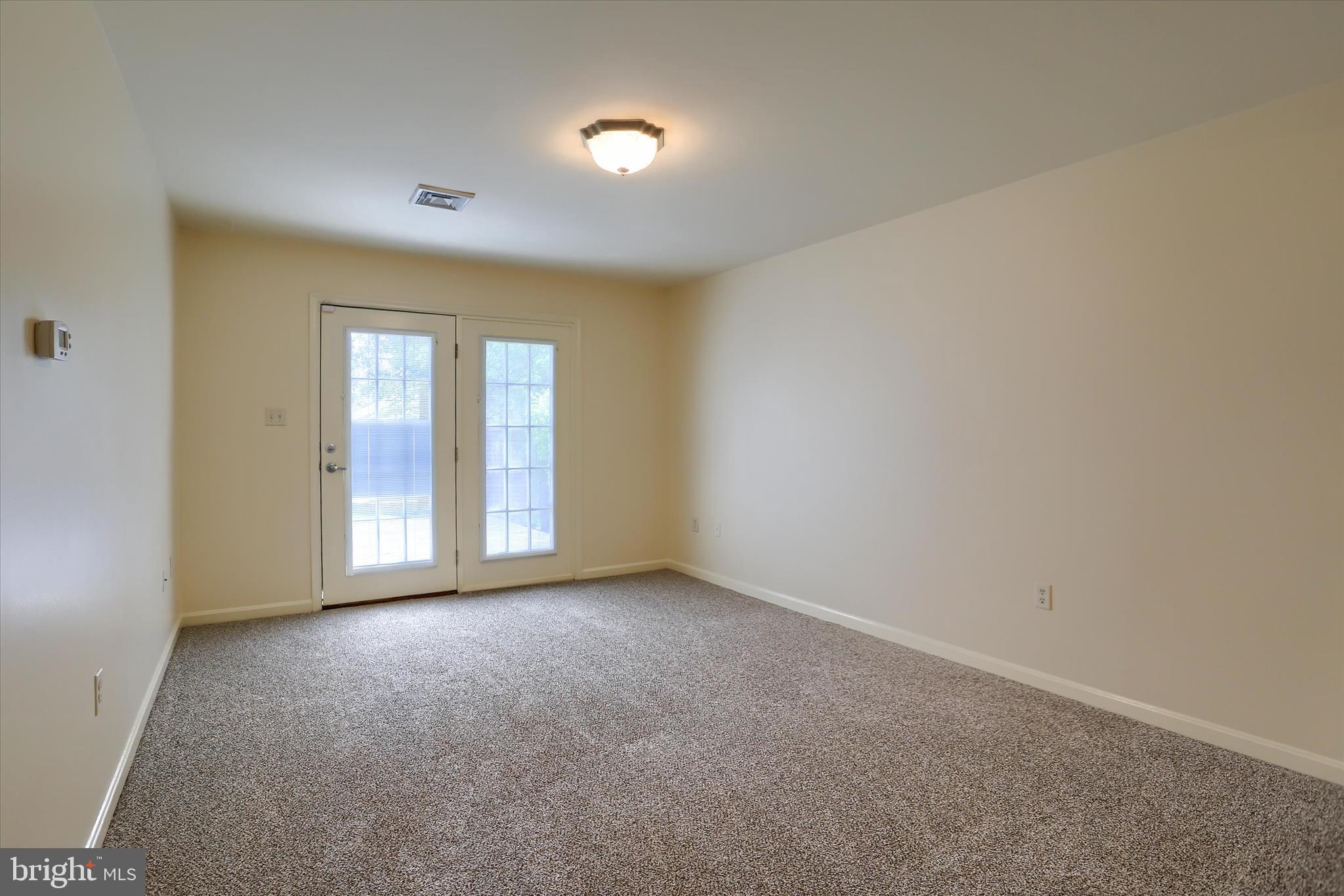 107 Fawn Ridge North Harrisburg, PA 17110 - Photo 16 of 40 a view of an empty room with a window and a kitchen