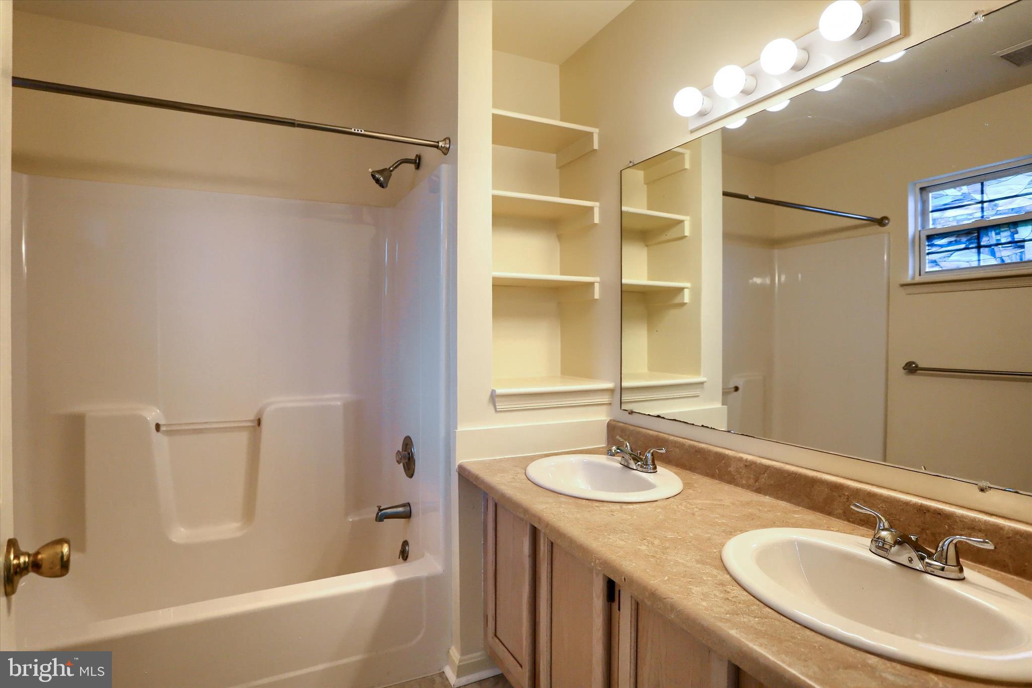 107 Fawn Ridge North Harrisburg, PA 17110 - Photo 24 of 40 a bathroom with a granite countertop sink mirror toilet and bathtub