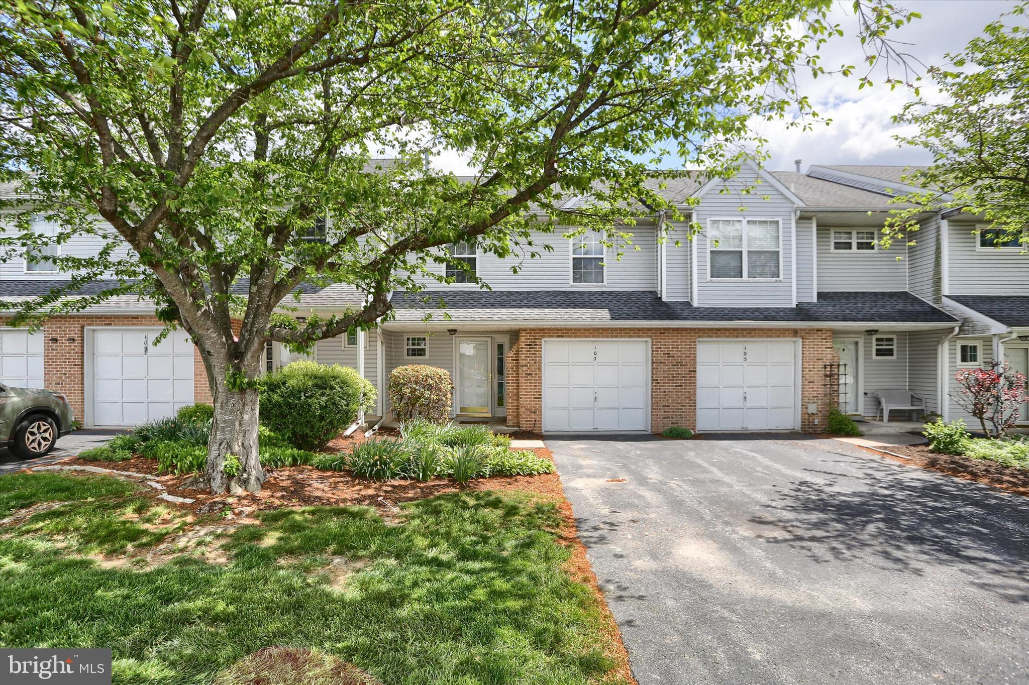 107 Fawn Ridge North Harrisburg, PA 17110 - Photo 3 of 40 a front view of a house with a garden and trees