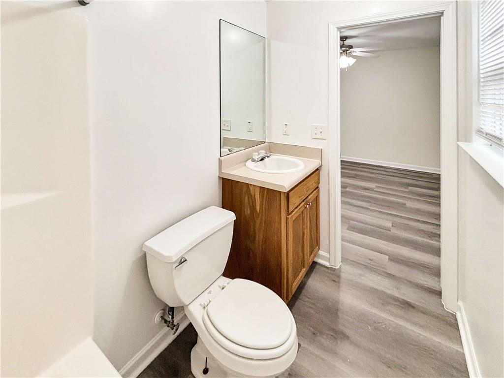 1400 Stonehaven Circle, Unit 1402 Cartersville, GA 30121 - Photo 14 of 23 a bathroom with a toilet a sink and mirror