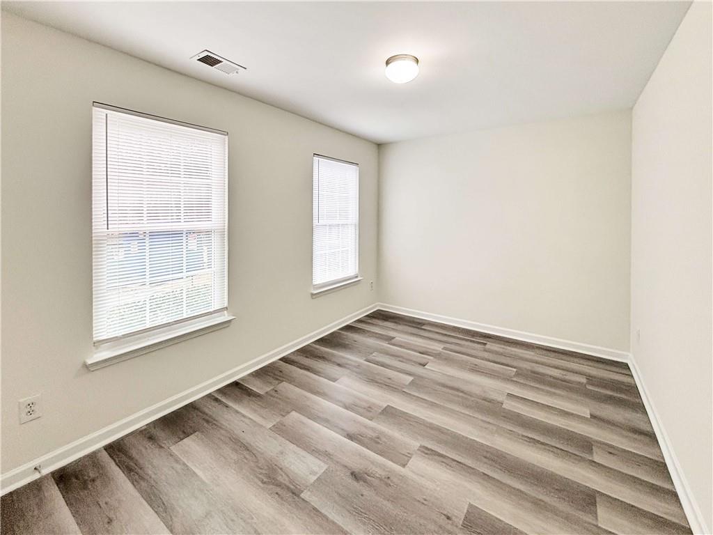 1400 Stonehaven Circle, Unit 1402 Cartersville, GA 30121 - Photo 15 of 23 a view of an empty room with wooden floor and a window