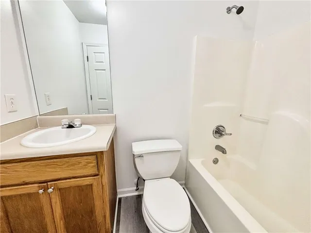 a white toilet sitting next to a bathroom sink