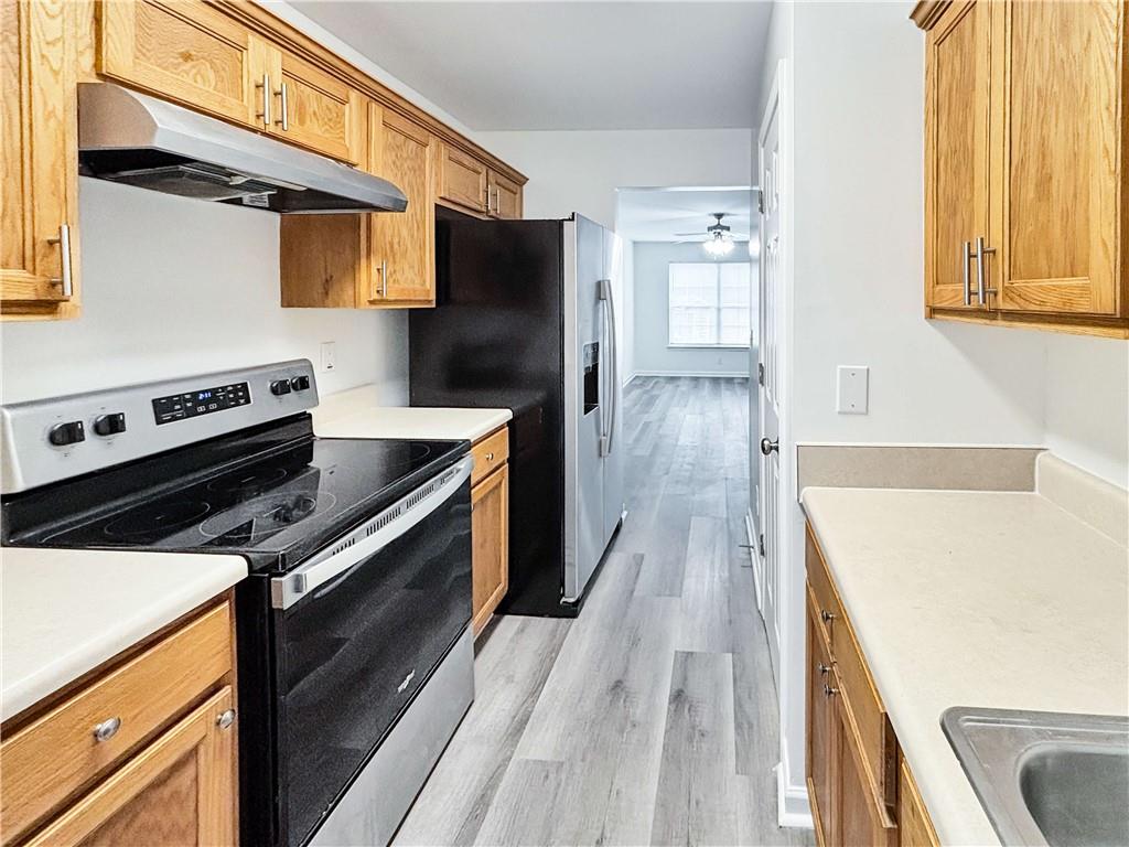 1400 Stonehaven Circle, Unit 1402 Cartersville, GA 30121 - Photo 7 of 23 a kitchen with a stove and a refrigerator