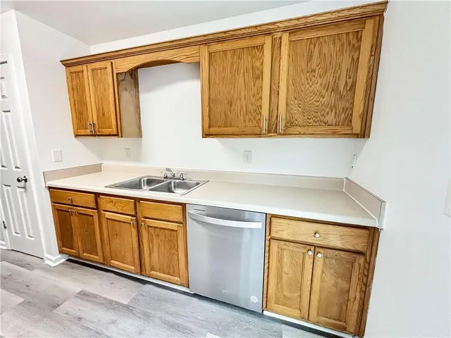 a kitchen with stainless steel appliances granite countertop a refrigerator and a stove