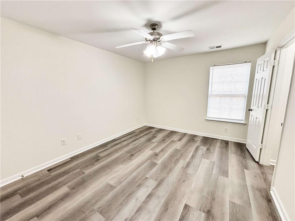 1400 Stonehaven Circle, Unit 1402 Cartersville, GA 30121 - Photo 10 of 23 wooden floor in an empty room with a window