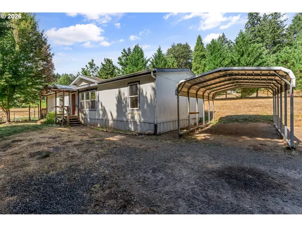 a view of a house with yard and a tree