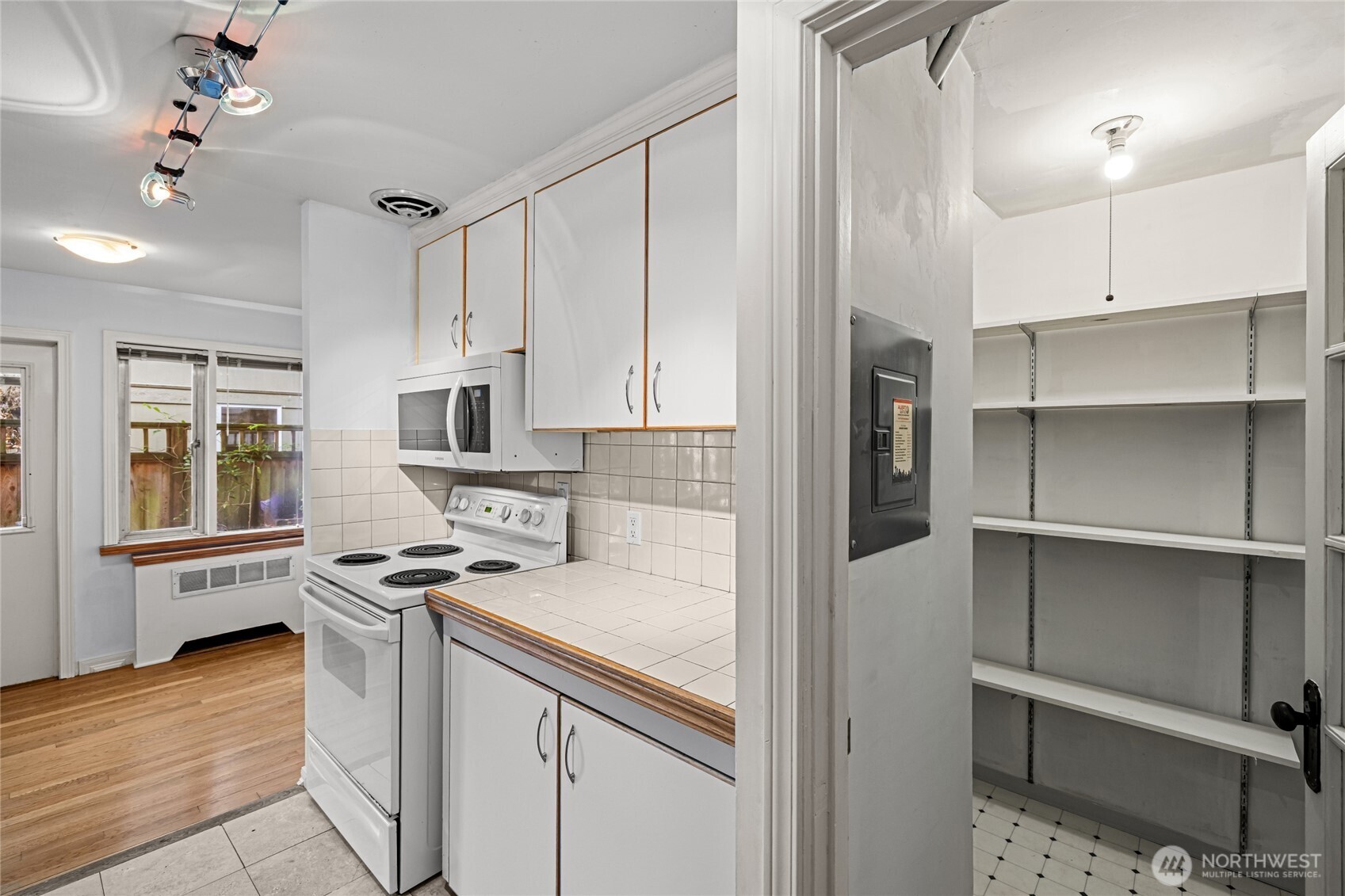 634 13th Avenue East, Unit 17 Seattle, WA 98102 - Photo 14 of 39 a kitchen with cabinets and stainless steel appliances