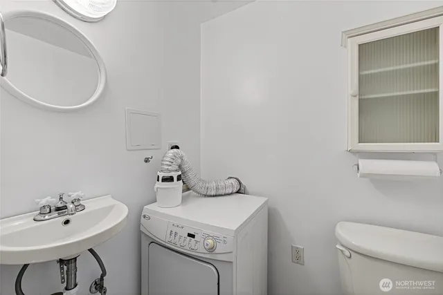 a bathroom with a sink a toilet and a mirror