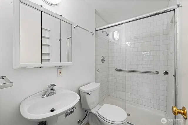 a bathroom with a sink toilet and shower