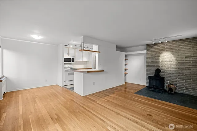 a view of a kitchen with wooden floor and a sink