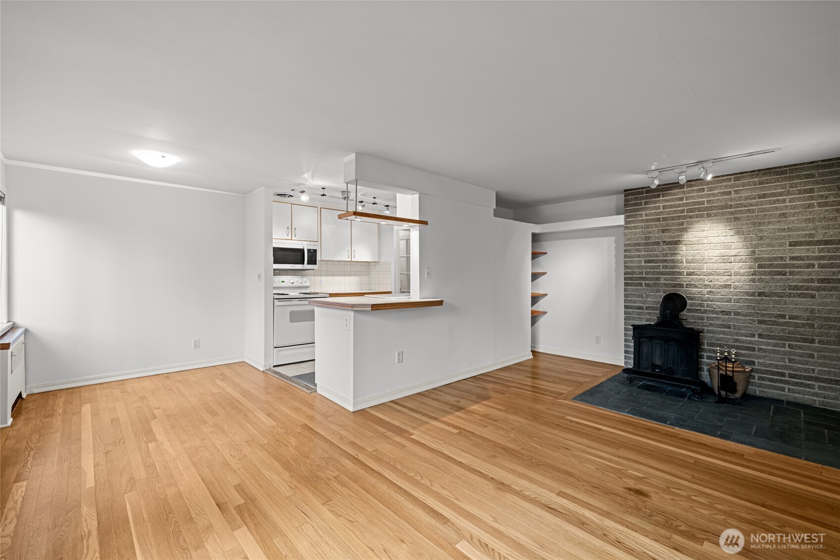 634 13th Avenue East, Unit 17 Seattle, WA 98102 - Photo 7 of 39 a view of a kitchen with wooden floor and a sink