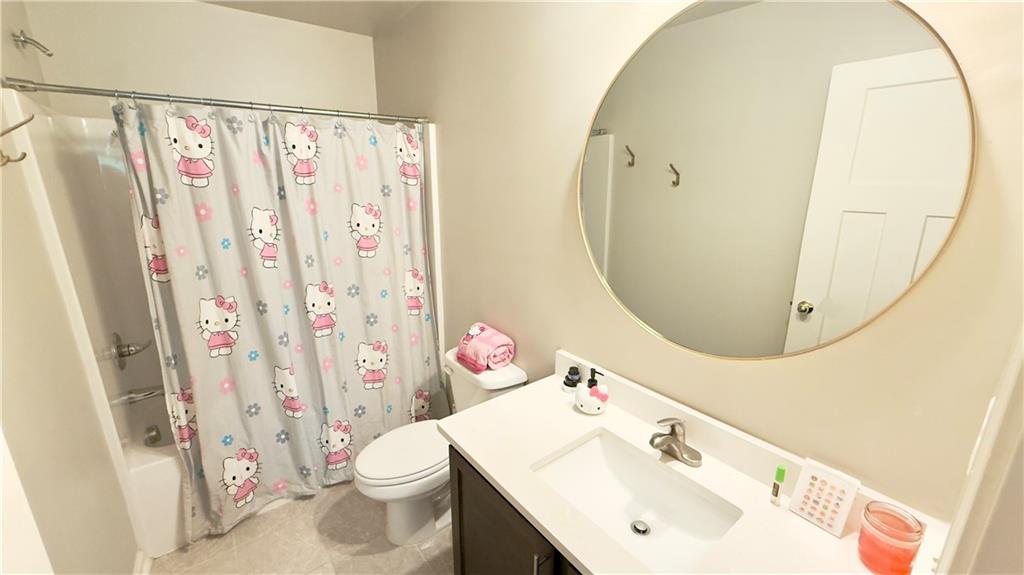 3370 Elkhorn Ridge Run Dacula, GA 30019 - Photo 21 of 29 a bathroom with a sink vanity mirror and toilet