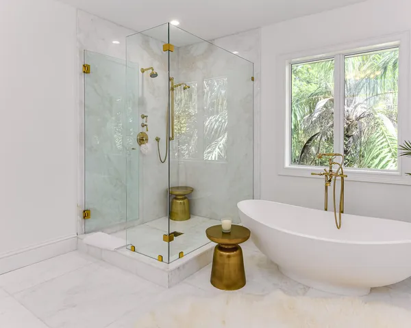 a bathroom with a tub a window and a shower