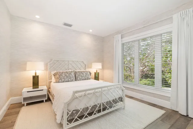 a bedroom with a bed and a night stand