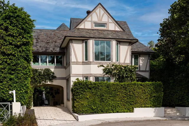 a front view of a house with a garden