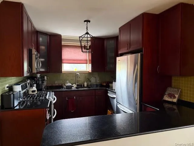 a kitchen with wooden cabinets a sink a stove and refrigerator