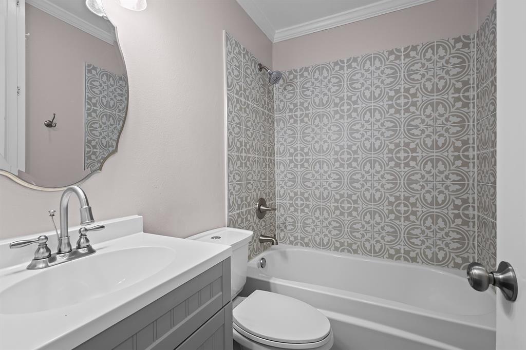 1135 Reed Circle Howe, TX 75459 - Photo 17 of 28 a bathroom with a granite countertop bathtub sink vanity mirror and toilet