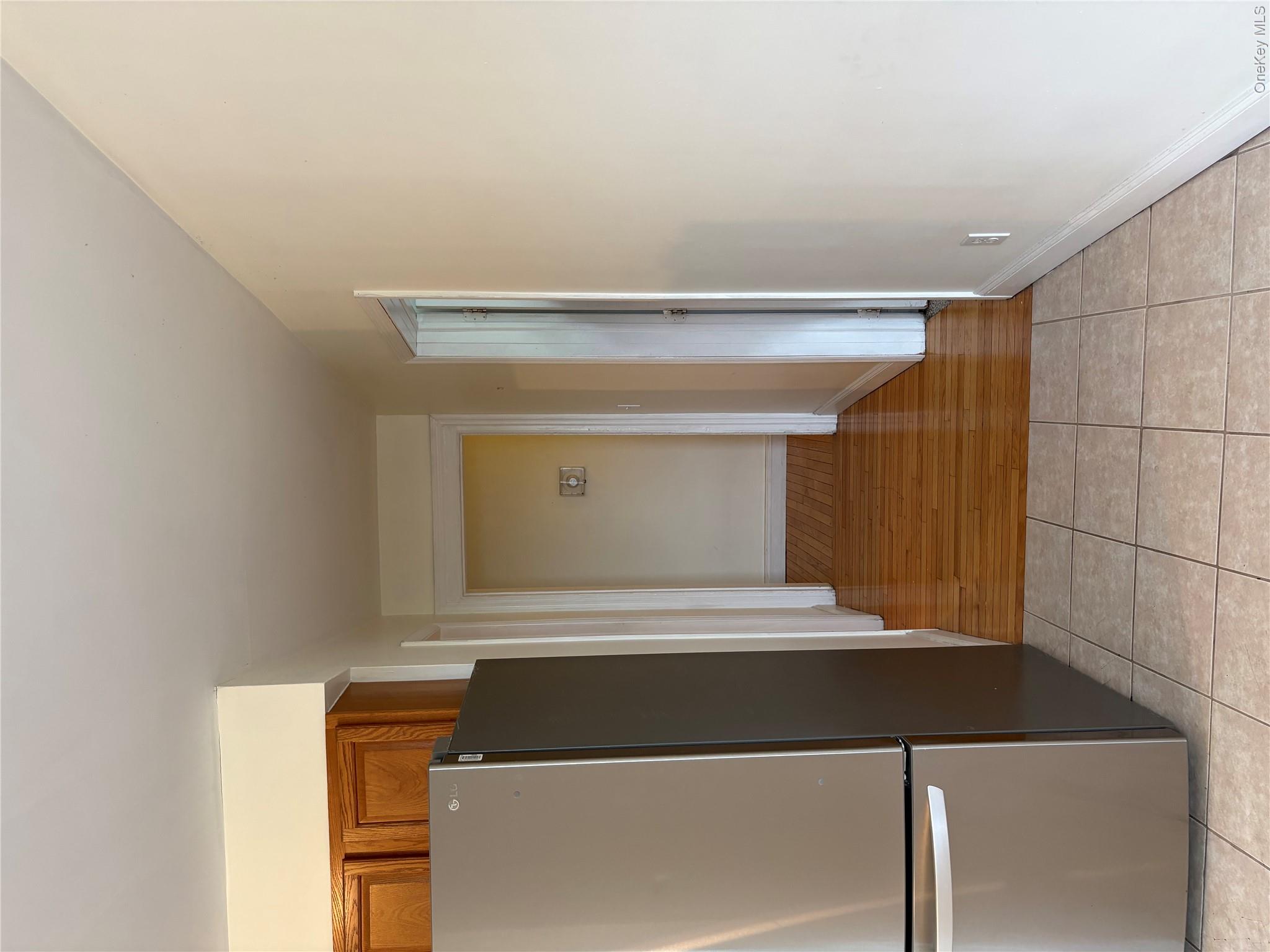 2 Morris Avenue, Unit 203 Cold Spring, NY 10516 - Photo 9 of 32 a view of a refrigerator in kitchen and an empty room