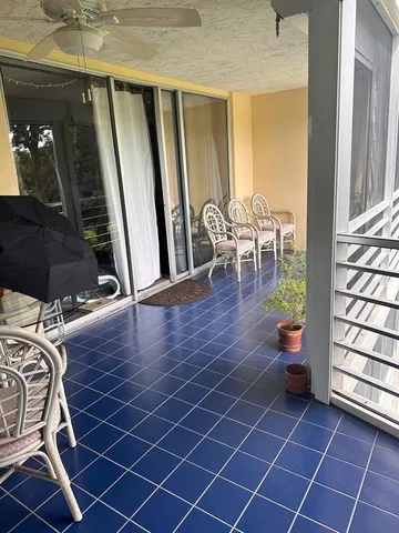 a view of a hallway with wooden floor and windows