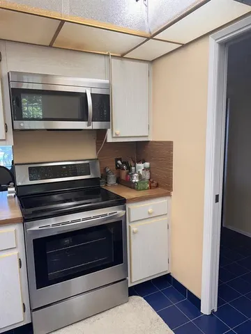 a kitchen with stainless steel appliances granite countertop a stove and a microwave