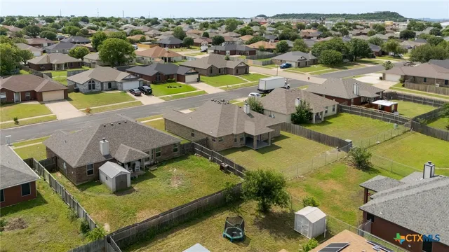 an aerial view of residential houses with outdoor space